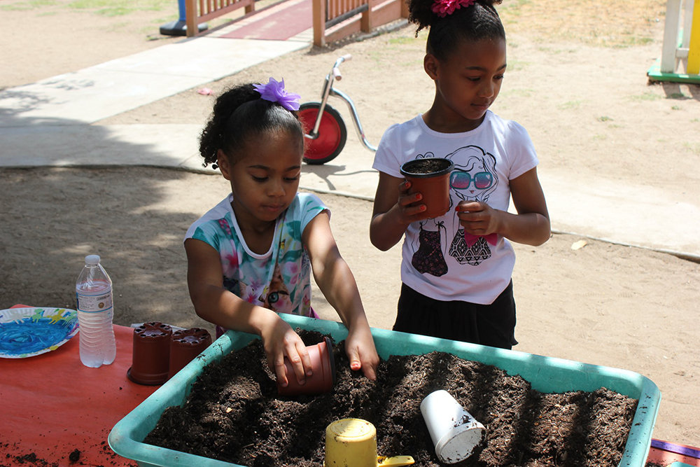 happy girls planting at a Preschool & Daycare Serving El Cajon, Lakeside and Santee CA